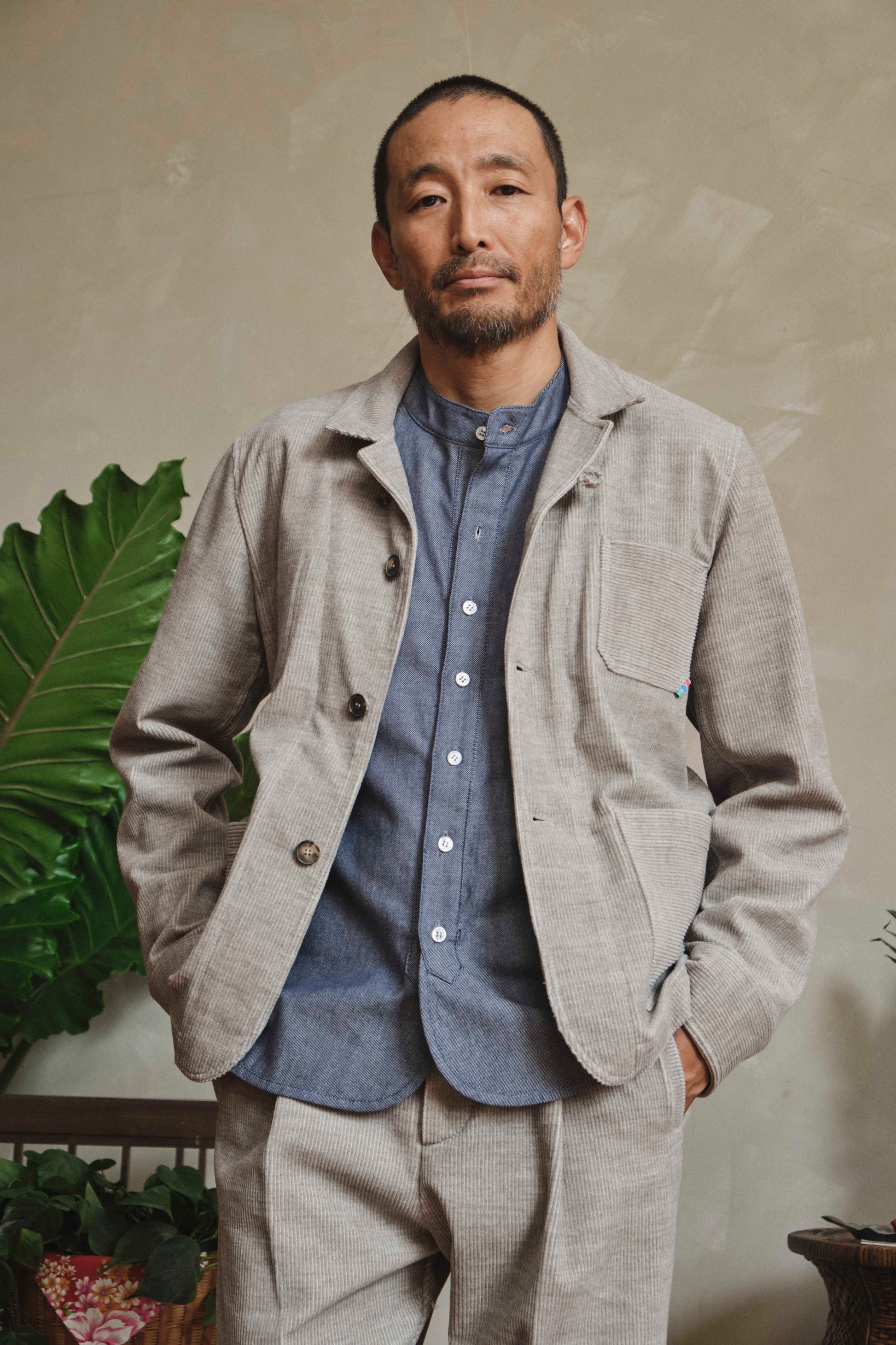 Model wearing grey heather corduroy chore jacket, front view