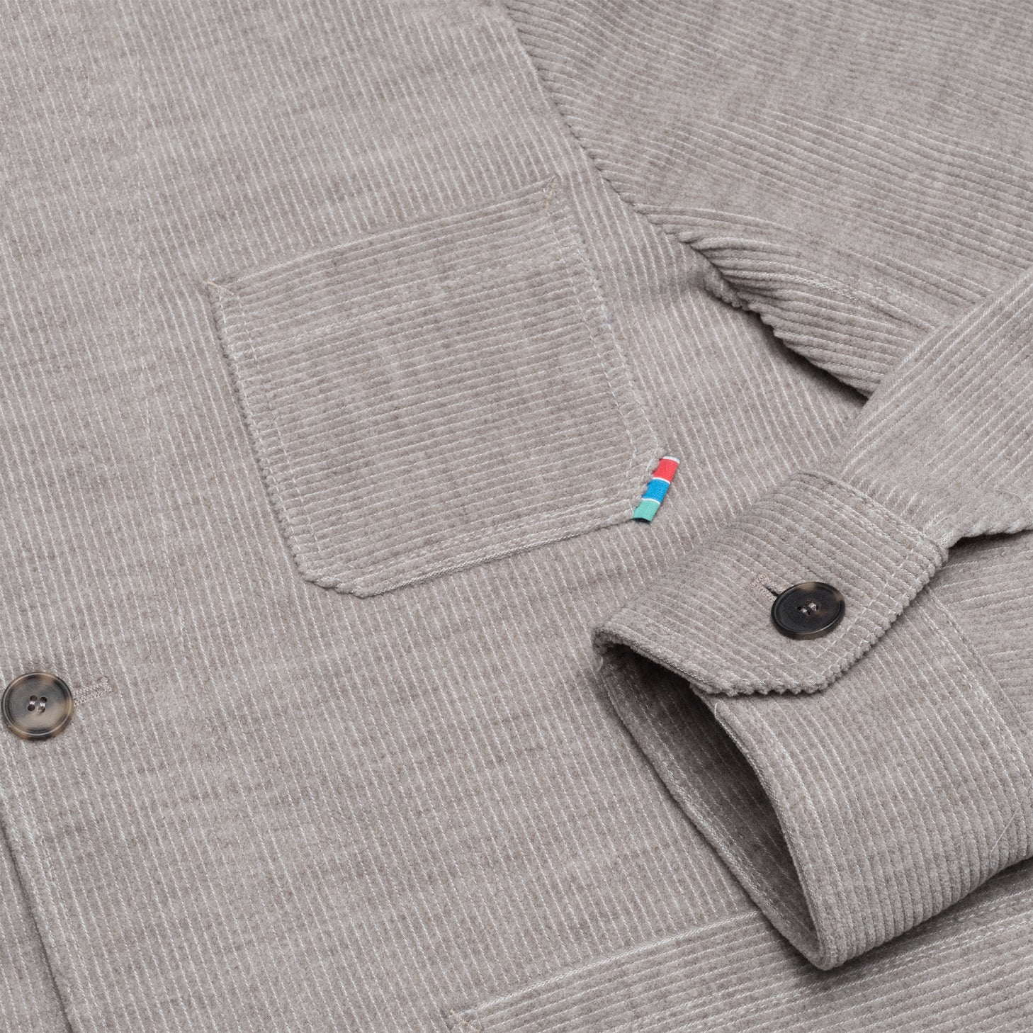Chest pocket with Gaji bag stripe tab on grey corduroy jacket