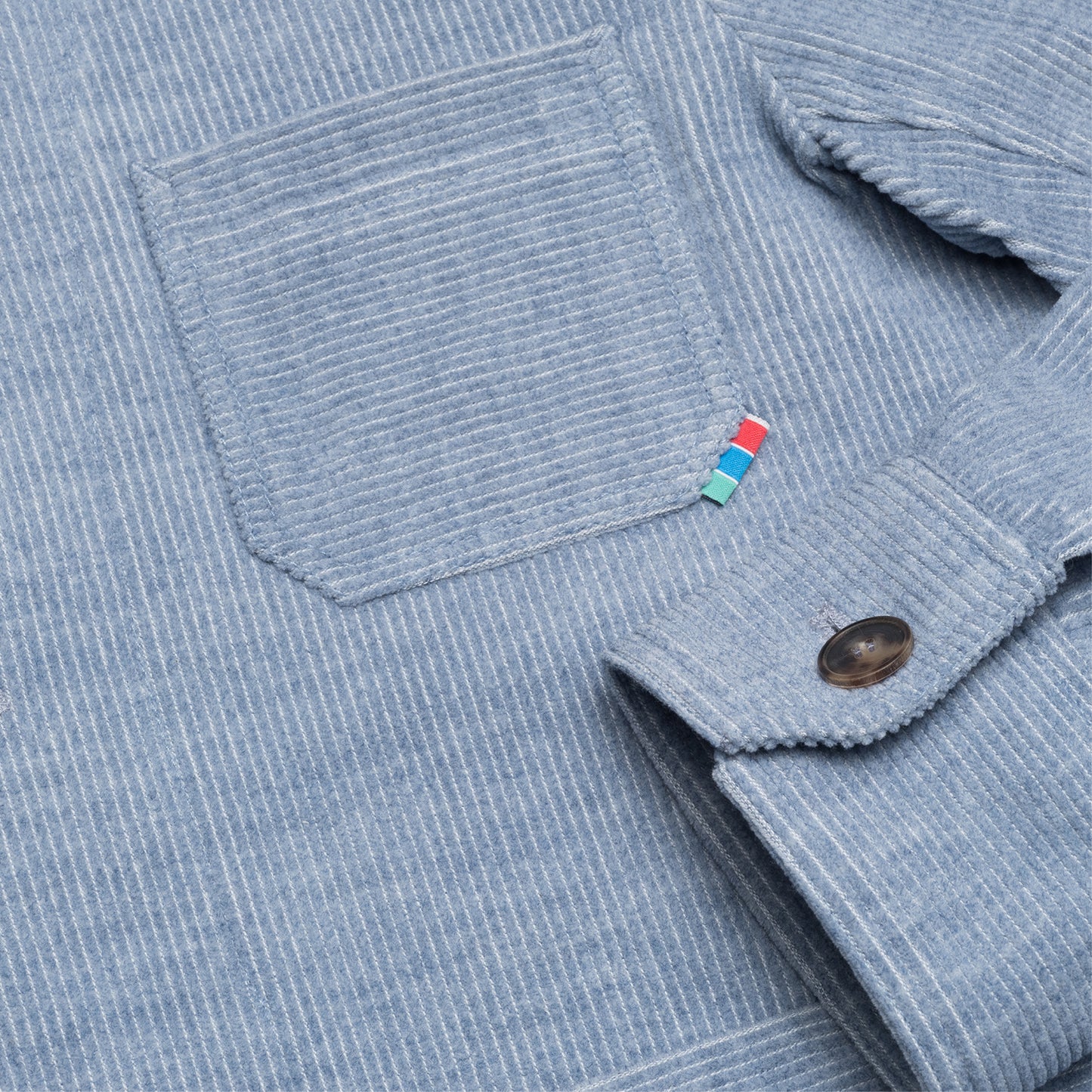 Chest pocket with Gaji bag stripe tab on blue corduroy jacket