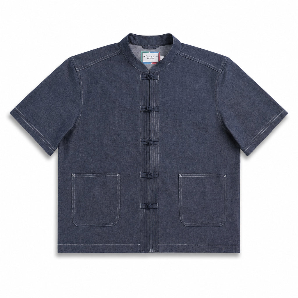 A dark indigo blue short-sleeve mandarin collar jacket with traditional Chinese frog closures and two front patch pockets, shown flat on a white background.